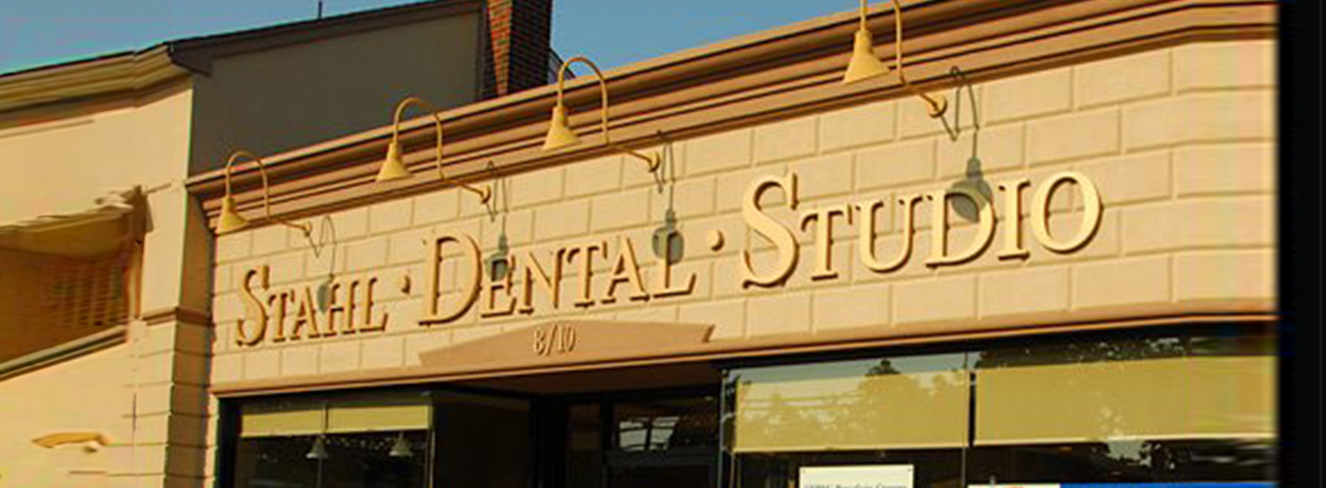 The image shows a storefront with a sign that reads Stahl Dental Studio.