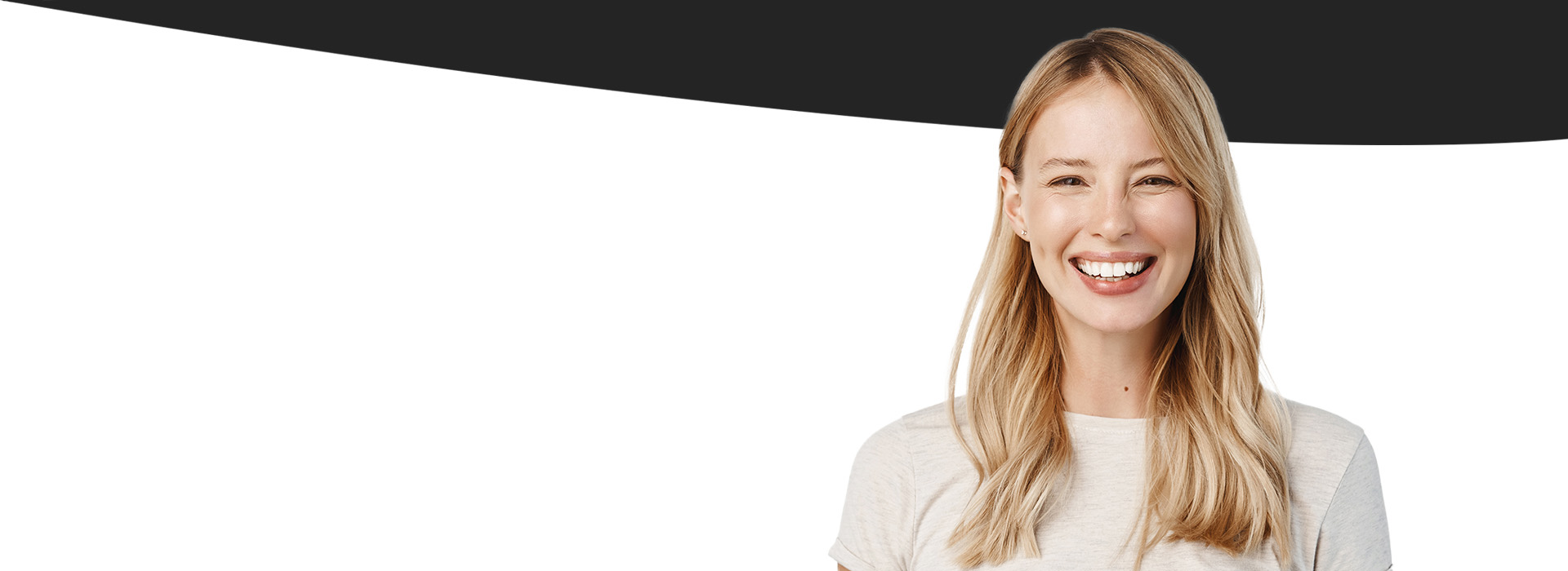 The image shows a smiling woman with blonde hair, wearing a white top against a plain background.