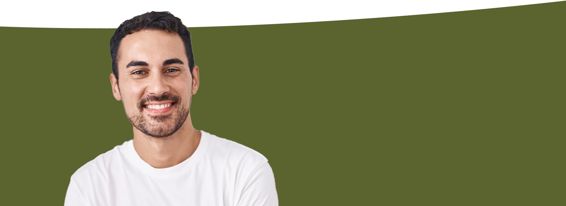 The image is a photograph of a man smiling and looking directly at the camera, set against a blurred background that appears to be a greenish-blue gradient.