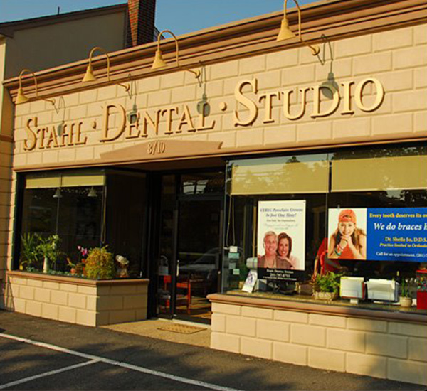 The image shows a storefront with the sign Stahl Dental Studio prominently displayed above a window.